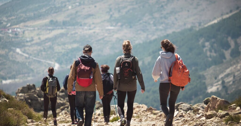 A group of people hiking along a rocky mountain trail, enjoying nature and adventure.